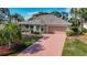 Attractive single-Gathering home with a spacious driveway, a two-car garage, and a well-manicured lawn at 1402 Bluewater Dr, Sun City Center, FL 33573