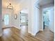 Inviting foyer with decorative front door, modern light fixture, wood flooring and arched entryways to other rooms at 1402 Bluewater Dr, Sun City Center, FL 33573