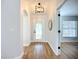 Bright foyer featuring wood-look tile, decorative glass door, modern light fixture, and access to other rooms at 1402 Bluewater Dr, Sun City Center, FL 33573