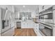 Bright kitchen boasts stainless steel appliances, granite counters, and wood flooring at 1402 Bluewater Dr, Sun City Center, FL 33573