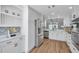 Well-appointed kitchen featuring white cabinetry, stainless steel appliances, and an open layout at 1402 Bluewater Dr, Sun City Center, FL 33573