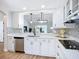 Updated kitchen with stainless appliances, sleek counters, and patterned backsplash at 1402 Bluewater Dr, Sun City Center, FL 33573