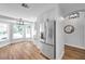 Spacious kitchen with stainless steel refrigerator, bay window and modern light fixture at 1402 Bluewater Dr, Sun City Center, FL 33573