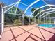 Large screened lanai with a pool, providing an ideal space for outdoor relaxation and entertainment at 1402 Bluewater Dr, Sun City Center, FL 33573