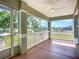 A screened-in front porch with a ceiling fan, offering a relaxing outdoor space at 1402 Bluewater Dr, Sun City Center, FL 33573