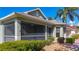 View of the home's side screened in lanai, showing the architecture and landscaping at 1402 Bluewater Dr, Sun City Center, FL 33573