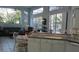 Open living space filled with natural light, large windows, comfortable seating, and tiled floors at 1803 Longview Ln, Tarpon Springs, FL 34689