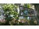 Unique stained glass hanging in window surrounded by greenery at 1803 Longview Ln, Tarpon Springs, FL 34689