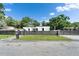 Modern home featuring a horizontal-slat fence, manicured lawn, and contemporary architecture at 18852 Tracer Dr, Lutz, FL 33549