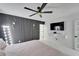Bright main bedroom with sleek black accent wall with modern lighting, tv, and a walk-in closet at 18852 Tracer Dr, Lutz, FL 33549