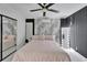Bright main bedroom with a modern ceiling fan and marble accent wall with modern decor at 18852 Tracer Dr, Lutz, FL 33549