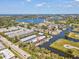 Aerial photo showcases waterfront condos with private docks, providing seamless access to the shimmering waters of the tranquil canal at 200 Meres Blvd # 26, Tarpon Springs, FL 34689