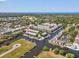Stunning aerial view of a waterfront condo community featuring private docks, picturesque canals, and lush tropical landscapes at 200 Meres Blvd # 26, Tarpon Springs, FL 34689
