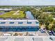 Aerial view of waterfront condos boasting private boat docks, lush surroundings, and stunning views of serene blue waters at 200 Meres Blvd # 26, Tarpon Springs, FL 34689