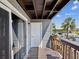 Balcony featuring a sliding glass door overlooking the waterfront and boat lift at 200 Meres Blvd # 26, Tarpon Springs, FL 34689