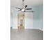 This bedroom features wood-look floors, ceiling fan and white sliding barn door to en-suite at 200 Meres Blvd # 26, Tarpon Springs, FL 34689