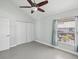 Bright bedroom with modern ceiling fan, light paint, wood-look floors, and double-door closet at 200 Meres Blvd # 26, Tarpon Springs, FL 34689