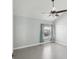 This light and airy bedroom features neutral paint, wood-look flooring, and a ceiling fan at 200 Meres Blvd # 26, Tarpon Springs, FL 34689