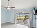 Light-filled bedroom with sliding glass doors opening to a private balcony overlooking a serene waterway at 200 Meres Blvd # 26, Tarpon Springs, FL 34689