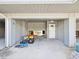 Covered parking space with a door and a 'Welcome' sign, offering convenient access at 200 Meres Blvd # 26, Tarpon Springs, FL 34689