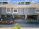 Exterior aerial view of townhouse featuring covered parking with individual unit access at 200 Meres Blvd # 26, Tarpon Springs, FL 34689