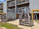 Exterior rear view of condo showing stairs and undercarriage at 200 Meres Blvd # 26, Tarpon Springs, FL 34689