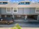 Exterior aerial view of a townhouse featuring covered parking with individual unit access at 200 Meres Blvd # 26, Tarpon Springs, FL 34689