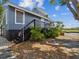 Exterior of waterfront home featuring a private deck and stairs at 200 Meres Blvd # 26, Tarpon Springs, FL 34689