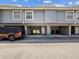 Exterior of a townhouse featuring covered parking and access to individual units at 200 Meres Blvd # 26, Tarpon Springs, FL 34689