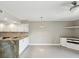 Open kitchen and dining area featuring granite countertops, stainless steel appliances, and updated cabinetry at 200 Meres Blvd # 26, Tarpon Springs, FL 34689