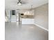 Spacious living area adjacent to the staircase and updated kitchen, featuring tile flooring and natural light at 200 Meres Blvd # 26, Tarpon Springs, FL 34689