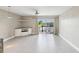 Inviting living room with tile floors, ceiling fan, and sliding glass doors showcasing picturesque waterfront views at 200 Meres Blvd # 26, Tarpon Springs, FL 34689