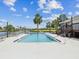 Community pool and waterfront view surrounded by lush landscaping and seating at 200 Meres Blvd # 26, Tarpon Springs, FL 34689