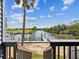 Scenic waterfront view from the deck, with a boat lift, canal, blue sky, and lush greenery at 200 Meres Blvd # 26, Tarpon Springs, FL 34689