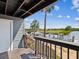 Balcony view of the waterfront featuring a boat lift, lush greenery, and clear blue sky at 200 Meres Blvd # 26, Tarpon Springs, FL 34689