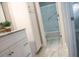 Bathroom featuring a marble-look shower, vanity with storage, and a decorative mirror at 208 Villa Dr # 208, Osprey, FL 34229