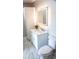 Bathroom featuring a marble top vanity and a decorative lighted mirror at 208 Villa Dr # 208, Osprey, FL 34229