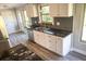Bright kitchen featuring white cabinetry, granite countertops, and modern fixtures, providing a stylish cooking space at 208 Villa Dr # 208, Osprey, FL 34229