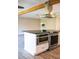 Elegant kitchen island featuring built-in microwave and oven, with granite countertop and stainless steel fixtures at 208 Villa Dr # 208, Osprey, FL 34229