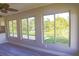 Bright living room featuring new wood flooring and large windows with views of the surrounding greenery at 208 Villa Dr # 208, Osprey, FL 34229