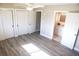 Bright main bedroom with grey wood floors, ceiling fan, and bathroom access at 208 Villa Dr # 208, Osprey, FL 34229