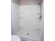 Bathroom shower with shelving and adjustable shower head at 208 Villa Dr # 208, Osprey, FL 34229