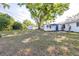 Large backyard featuring mature trees, a storage shed, and a patio at 2244 Glenmoor N Rd, Clearwater, FL 33764