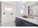 Bathroom with dual sinks, gold hardware, and a tiled shower at 2244 Glenmoor N Rd, Clearwater, FL 33764