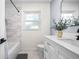 Well-lit bathroom with white vanity and a shower-tub combo at 2244 Glenmoor N Rd, Clearwater, FL 33764