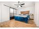 Bedroom featuring wood-look flooring, a ceiling fan, and stylish sliding doors at 2244 Glenmoor N Rd, Clearwater, FL 33764