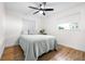Comfortable bedroom with a ceiling fan, wood flooring, and natural light at 2244 Glenmoor N Rd, Clearwater, FL 33764