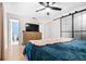 Bedroom features a ceiling fan, stylish sliding doors, and ensuite bathroom at 2244 Glenmoor N Rd, Clearwater, FL 33764