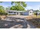 Charming single-story home boasts a large driveway and a well-maintained front yard with mature trees at 2244 Glenmoor N Rd, Clearwater, FL 33764