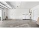 Spacious garage area featuring a washer, dryer, water heater and access door at 2244 Glenmoor N Rd, Clearwater, FL 33764